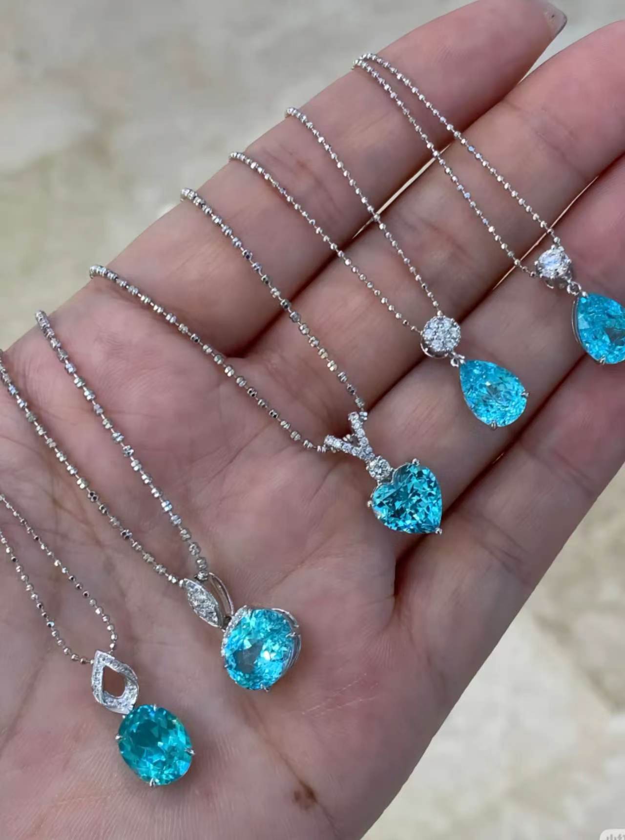 Row of pendant necklaces resting in an open palm